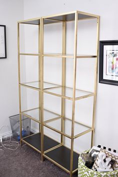 a gold shelving unit in the corner of a room