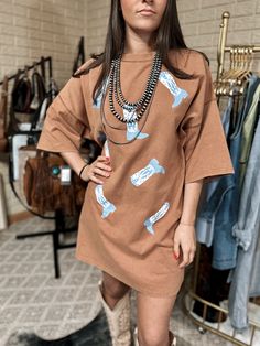 Western Boot Print Washed Tee Dress Short sleeves Round neck Western cowboy boots print Oversized model 5.4” shown in size small Fall Graphic Print Relaxed Fit Dress, Casual Brown Tops For Western-themed Events, Fall Graphic Print Cotton Dress, Cowboy Boots Print, Jewlery Earrings, Boots Print, Romper And Jacket, Boot Print, Western Boot