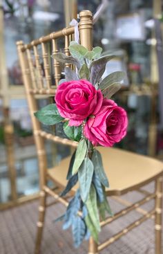 a bouquet of flowers sitting on top of a wooden chair