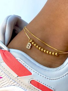 Elevate your look at the beach or pool this summer with our Curb Link Initial Anklet. Personalize to your initial. Perfect for stacking or wearing alone. These make a great gift to any of your loved ones. The anklet is made of stainless steel, so waterproof! The color remains perfect. Gold: 18k gold platingMaterial: Stainless steelLength: 21-25cm Waterproof jewelry Tarnish Free Hypoallergenic Glazd Pouch with every order Free US Shipping Easy Exchange & Return policy PRODUCT INFOAll our jewelry Initial Anklet, Initial Earrings Studs, 22k Gold Jewelry, Safety Pin Earrings, Waterproof Jewelry, Gold Piece, Solid Gold Jewelry, Safety Pin, Delicate Bracelet