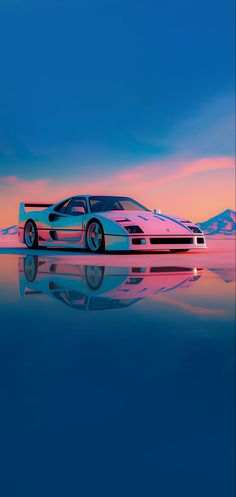 a car is parked on the water at sunset with mountains in the background and blue sky