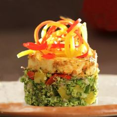 a plate with some food on top of it and vegetables in the middle, sitting on a table