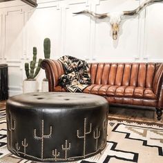 a living room filled with furniture and a cow skull on the wall