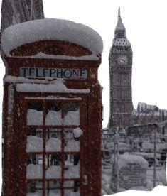 a phone booth covered in snow next to the big ben clock tower