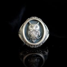 Special Design Oval Silver Owl Ring This unique oval ring combines the nobility of silver and the mysterious charm of the owl in magical harmony. From ancient mythologies to the present day, the owl has been associated with wisdom, prophecy and the keeper of secrets. For this reason, the ring not only elevates its owner's personal style, but also offers a comfortable wear with its oval shape that fits perfectly on your finger. The subtle relief patterns adorning the sides of the ring not only ad Oval Engraved Signet Ring For Collectors, Symbolic Nickel-free Oval Jewelry, Symbolic Oval Nickel-free Jewelry, Nickel-free Oval Symbolic Jewelry, Engraved Oval Symbolic Signet Ring, Symbolic Carved Sterling Silver Signet Ring, Symbolic Sterling Silver Oval Ring, Spiritual Sterling Silver Oval Signet Ring, Carved Sterling Silver Signet Ring Gift