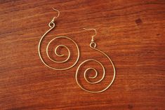 Spiral wire earrings made with gold color tarnish-resistant brass wire. Gold Spiral Wrap Earrings Nickel Free, Gold Wrap Earrings With Ear Wire, Gold Wire-wrapped Earrings, Gold Wire-wrapped Wrap Earrings, Gold Spiral Wrap Earrings With Ear Wire, Gold Swirl Earrings With Ear Wire, Wire Wrapped Swirl Earrings, Spiral Metal Earrings With Ear Wire, Handmade Spiral Gold Earrings