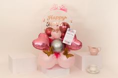 a bouquet of balloons and heliums with a happy mother's day card on it