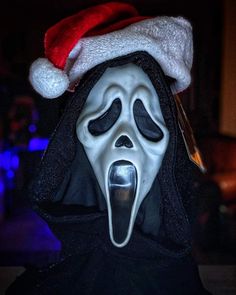 a person wearing a santa hat and scream mask