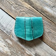 a small wallet sitting on top of a wooden floor