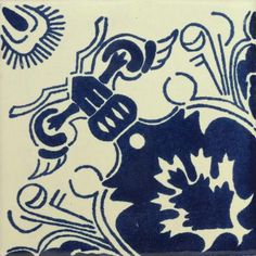 a blue and white tile with designs on it