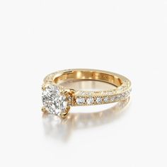 a yellow gold engagement ring with an oval cut diamond in the center and side stones