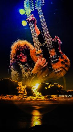 a man with long hair holding two guitars in front of his face and the sun behind him