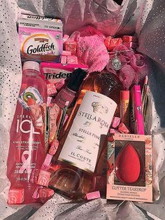 a bag filled with lots of different types of cosmetics and hygiene products on top of a table