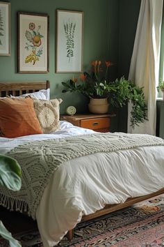 Cozy sage green bedroom decorated with floral art, houseplants, and earth-toned accents, blending calming colors and natural textures. Green Wood Bedroom Aesthetic, Sage Green And Red Bedroom, Calm Bedroom Ideas, Olive Bedroom, Bedroom Upgrade, Bedroom Orange, Sanctuary Bedroom