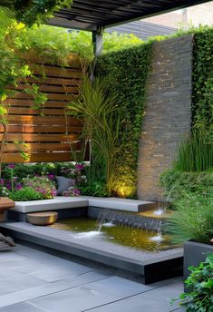 an outdoor garden with water feature and seating area