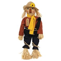 a scarecrow doll with a yellow scarf and hat