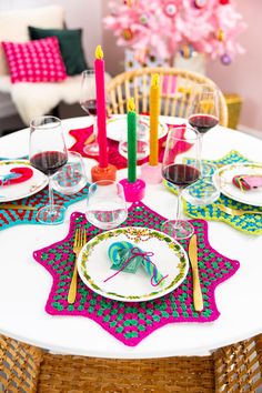 the table is set with colorful plates and place settings