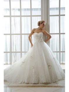 a woman in a white wedding dress posing for the camera