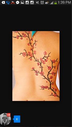 the back of a woman's body with flowers on it