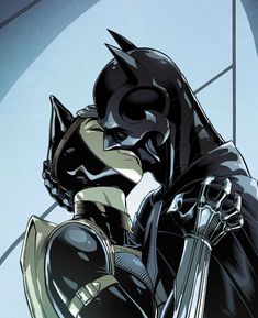 the batman and catwoman are hugging each other