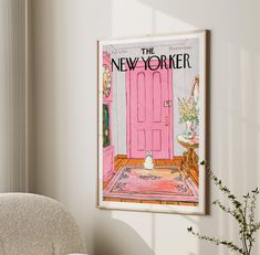 a pink door hangs in the corner of a room with a white chair and potted plant