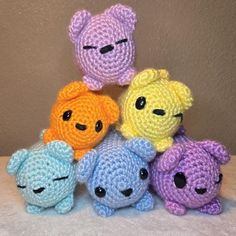 a group of crocheted stuffed animals sitting next to each other