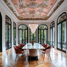 an elegant dining room with chandelier, chairs and large table surrounded by windows