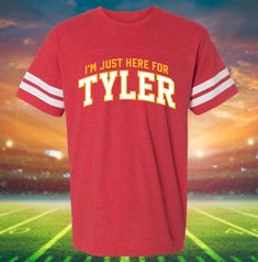 We are celebrating all things Tyler Hynes this upcoming Christmas! We can't wait to see him in his latest Hallmark Christmas movie, "Holiday Touchdown." This shirt is perfect for a movie-watching holiday party! Check out our store for more designs. **ABOUT DRESSING FESTIVE** Welcome to my shop, Dressing Festive! I've been selling festive tees on my website for a while now, but recently started an Etsy Store, so welcome to my page! Here at Dressing Festive, we believe in celebrating in style all year long. Check back often for new designs for all your favorite holidays and not-so-official holidays. You'll find that we are your go-to place for almost every occasion and for designs featuring your favorite feel-good TV Movies! Make sure to check out our other designs on Etsy! **ABOUT OUR DESIG Red Tops With Name Print For Sports Events, Red School Spirit Top With Name Print, Red Top With Name Print For School Spirit, Red Tops With Name Print For School Spirit, Game Day Red T-shirt With Name Print, Red T-shirt With Name Print For Game Day, Red Team Spirit Tops With Name Print, Red T-shirt With Name Print For Sports Events, Red Name Print T-shirt For Game Day