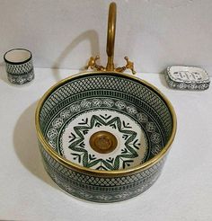 a bowl sink sitting on top of a white table