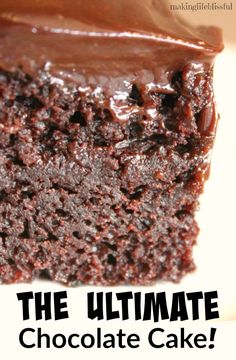 a close up of a piece of cake with chocolate frosting on it and the words, the ultimate chocolate cake