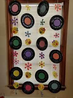 a window decorated with many different colored discs