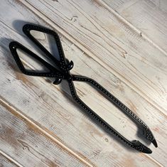 a pair of black glasses sitting on top of a wooden floor