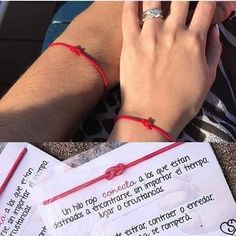 a man wearing a red string bracelet with a ring on his left hand and a note attached to his right wrist