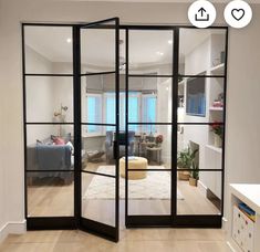 an open living room with glass doors leading to the bedroom and dining area in the background