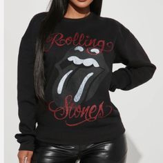 The Rolling Stones Sweatshirt Washed Black Cotton-Blend Fleece. This Cozy, Lightly Distressed Style Features "Rolling Stones Tongue Logo With Distressed Lettering Paired With A Red Glitter! Rib-Knit Crewneck And Cuffs. Drop Shoulders. Pulls Over. 50% Cotton, 50% Polyester. New Made In U.S. The Rolling Stones Black Washed Graphic Sweatshirt Black Fitted Graphic Print Sweatshirt, Fitted Black Graphic Sweatshirt, Fall Letter Print Top For Night Out, Graphic Print Long Sleeve Tops For Night Out, Long Sleeve Graphic Print Top For Night Out, Black Graphic Print Top For Winter, Black Graphic Print Top For Fall, Distressed Lettering, Rolling Stones Shirt