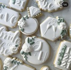 decorated wedding cookies are arranged on a table