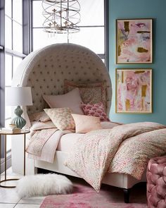 a bedroom with a bed, chair and pictures on the wall above it's headboard