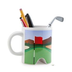 a golf mug with pencils and markers in it