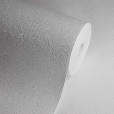 a roll of white toilet paper sitting on top of a counter