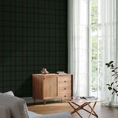 a living room with a couch, coffee table and large window in the back ground