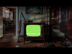 an old fashioned television with green screen sitting in the middle of a room filled with furniture