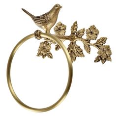 a gold ring with a bird sitting on it's side and flowers in the middle