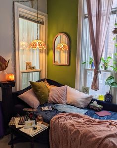 a bedroom with green walls and lots of pillows