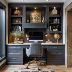 a home office with built - in desk and cabinets