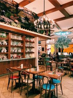 the inside of a restaurant with tables and chairs