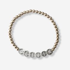 the gold beaded bracelet has three small beads with silver letters that spell out love