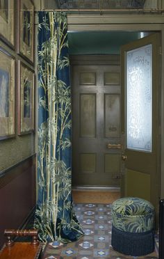 an entry way with a chair and painting on the wall