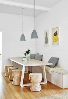 a dining room table with benches and stools