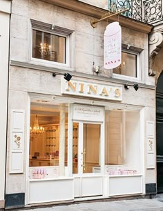 a store front with an awning on the top floor and windows above it that says innas