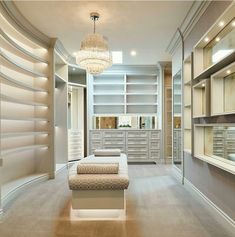 an empty room with shelves, drawers and a chandelier